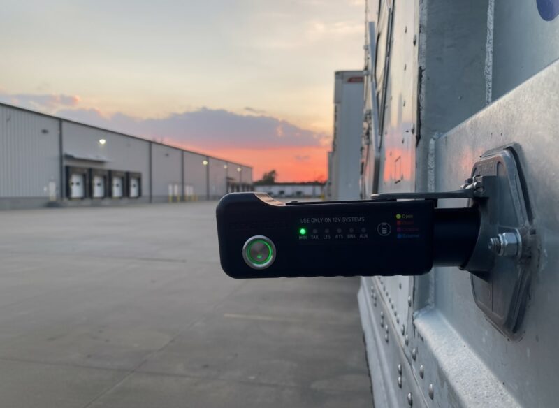 Pocket Tester connected to trailer light port during evening test